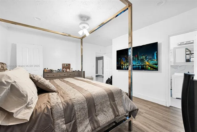 a bedroom with a bed and a flat screen tv