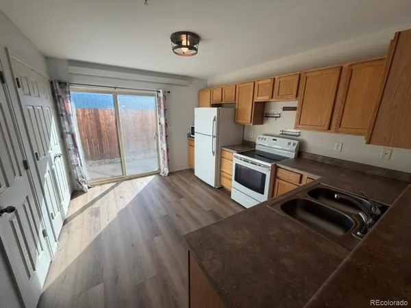 a kitchen with stainless steel appliances a stove a refrigerator a sink and dishwasher