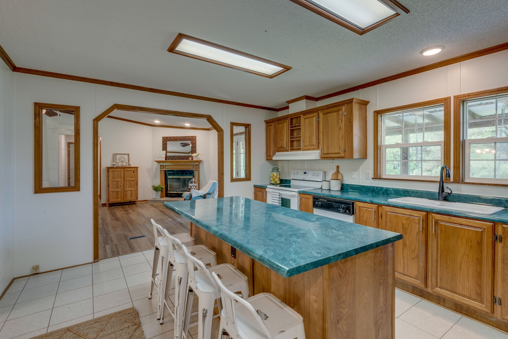 7289 Anderson Road Fairview, TN 37062 - Photo 25 of 51 a kitchen with granite countertop a stove a sink a dining table and chairs