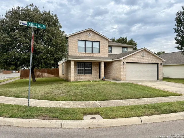 a view of a yard in front view of a house