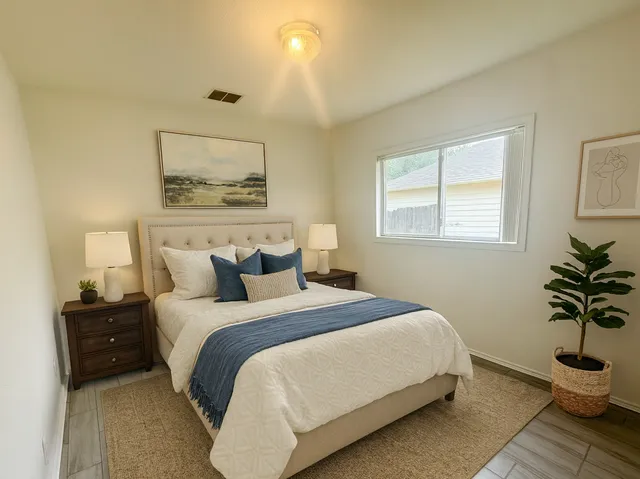 a bedroom with a bed and window