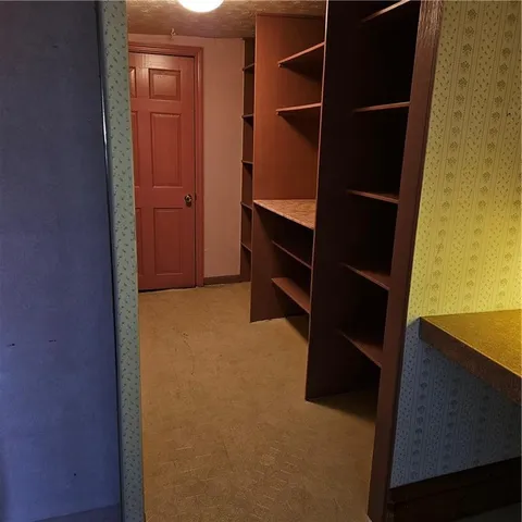 a view of a room with an empty space and a window