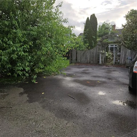 a view of a dirt road and trees