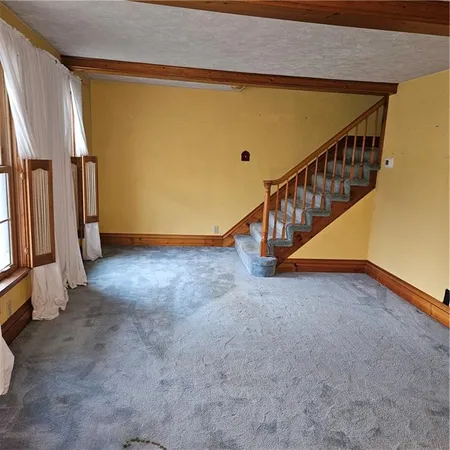 a view of an empty room with stairs