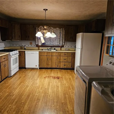 a kitchen with a wooden floor and a stove top oven