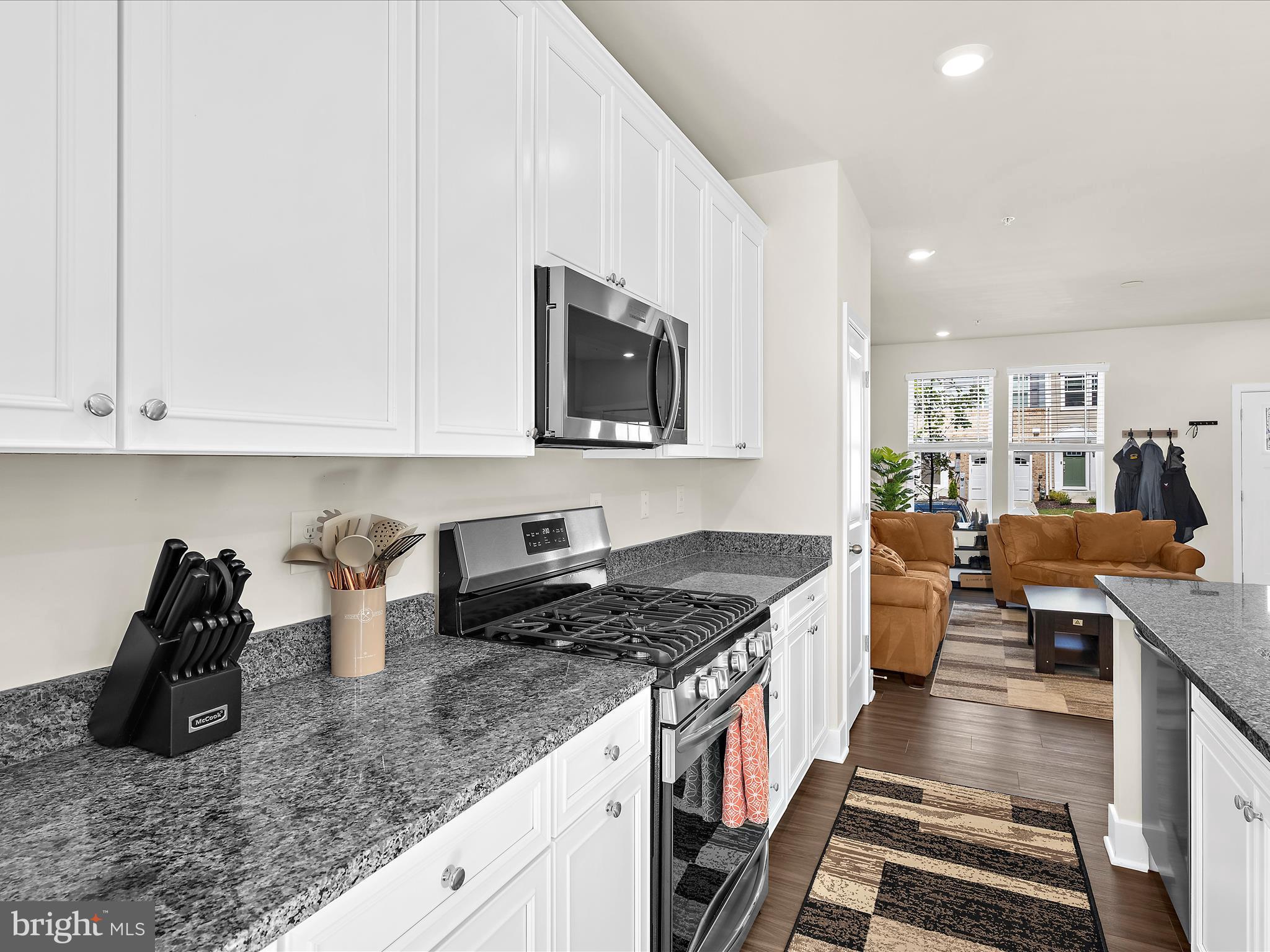2324 Woodlands Road Baltimore, MD 21244 - Photo 11 of 44 a kitchen with stainless steel appliances granite countertop a sink stove and cabinets