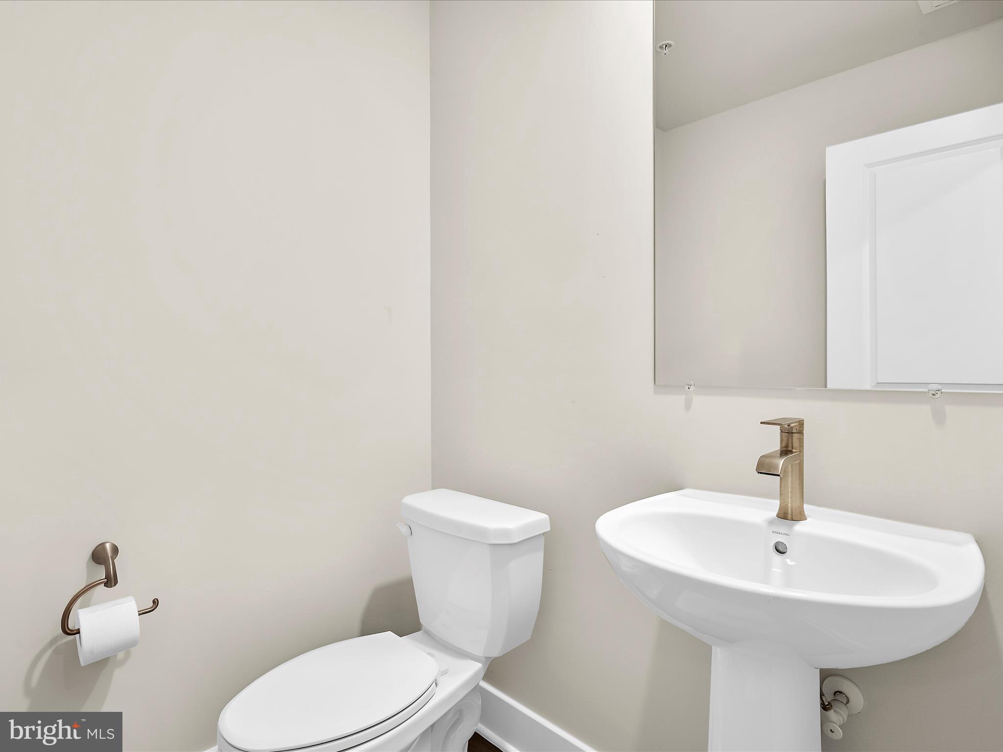 2324 Woodlands Road Baltimore, MD 21244 - Photo 20 of 44 a bathroom with a toilet a sink and mirror