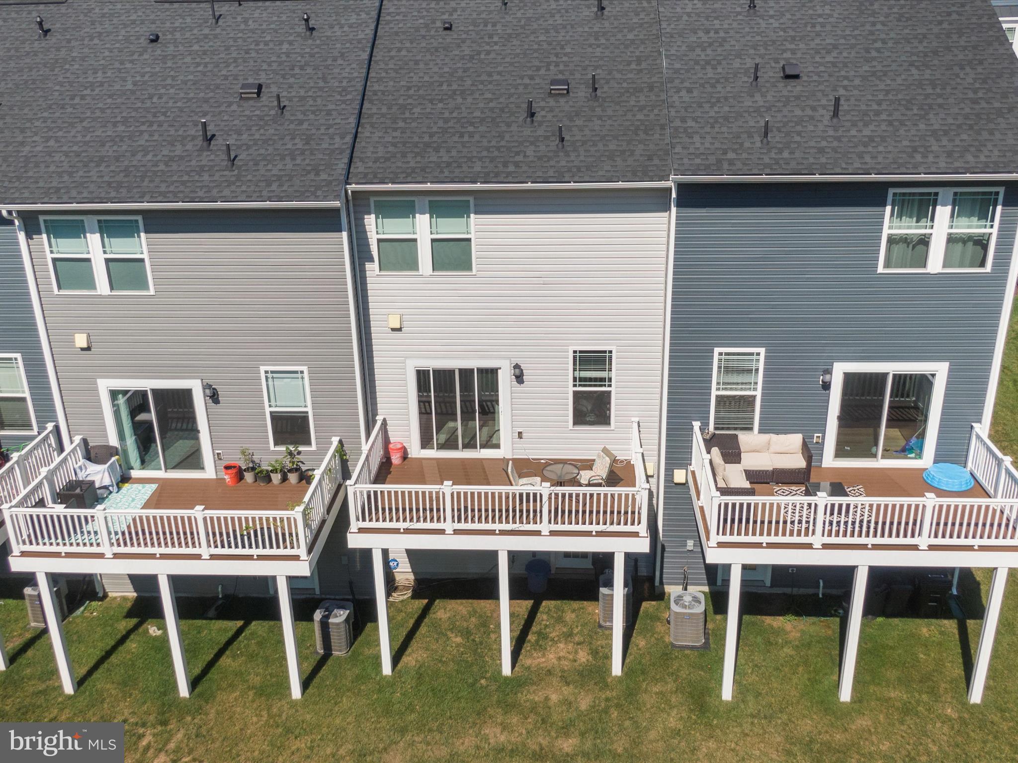 2324 Woodlands Road Baltimore, MD 21244 - Photo 35 of 44 a balcony with a table and chairs and potted plants