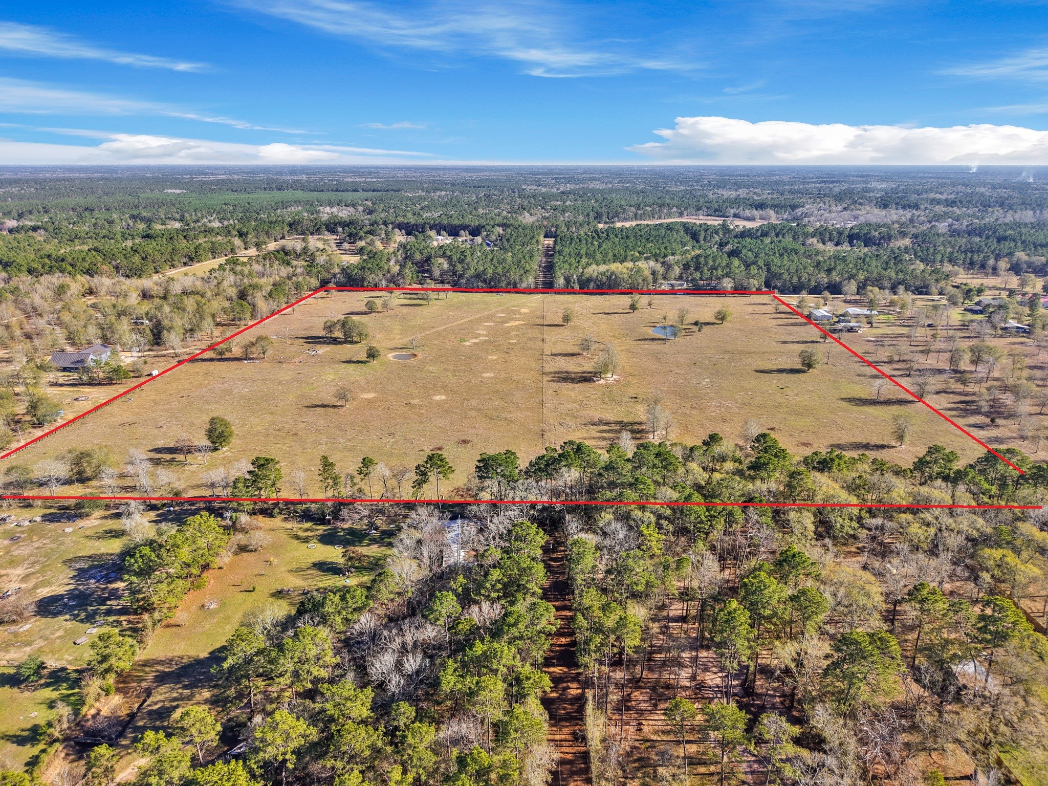 9789 North Walker Road Cleveland, TX 77328 - Photo 6 of 10 With long sightlines across the property and surrounding wooded acreage, the land provides a true sense of scale and seclusion while still being accessible to neighboring homes.