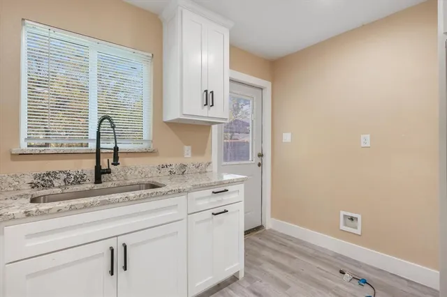 a kitchen with a sink cabinets and a window