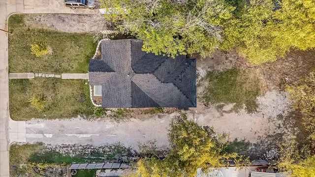 an aerial view of a house with a yard