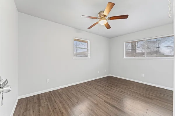 a view of room with wooden floor and ceiling fan