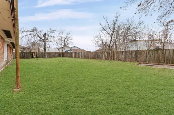 a view of a backyard with large trees