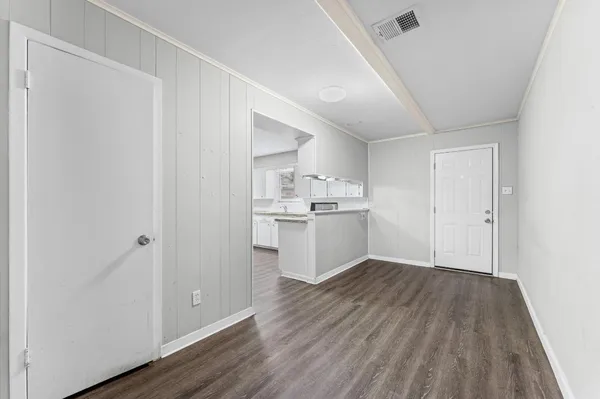a view of kitchen empty room with wooden floor