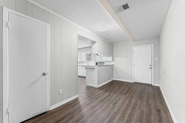 a view of kitchen empty room with wooden floor
