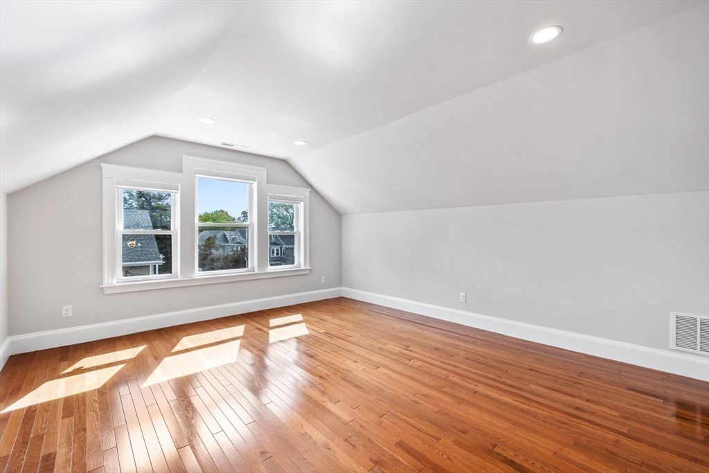 582 High Street, Unit 2 Medford, MA 02155 - Photo 13 of 27 an empty room with wooden floor and windows