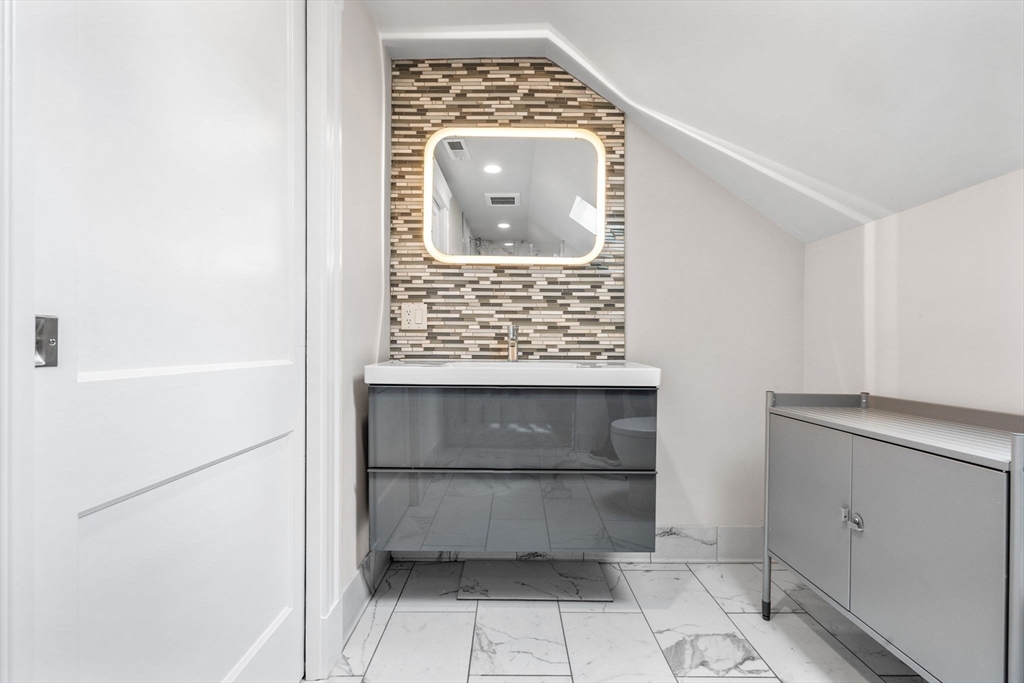 582 High Street, Unit 2 Medford, MA 02155 - Photo 15 of 27 a bathroom with a window and a mirror