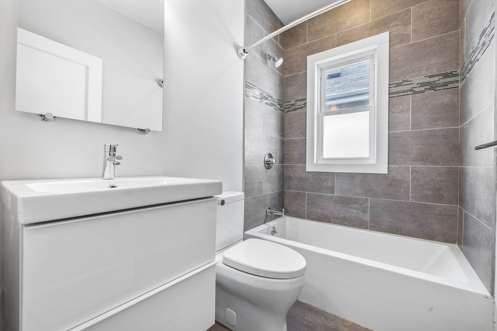 582 High Street, Unit 2 Medford, MA 02155 - Photo 19 of 27 a bathroom with a sink a toilet and shower