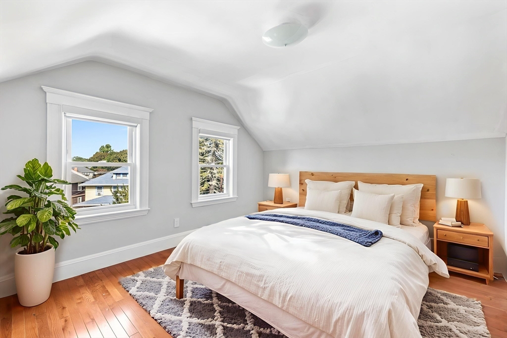 582 High Street, Unit 2 Medford, MA 02155 - Photo 22 of 27 a bedroom with a large bed and a potted plant