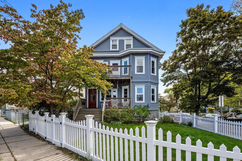 582 High Street, Unit 2 Medford, MA 02155 - Photo 26 of 27 a front view of a house with a garden
