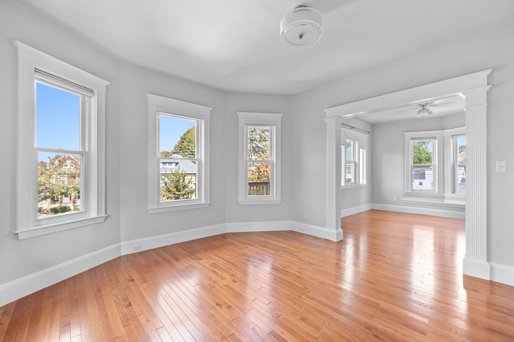 582 High Street, Unit 2 Medford, MA 02155 - Photo 9 of 27 a view of an empty room with window and wooden floor