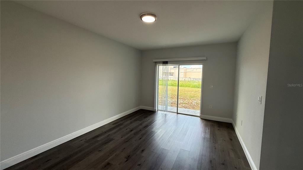 11079 Kimberly Avenue Englewood, FL 34224 - Photo 5 of 14 a view of an empty room with wooden floor and a window