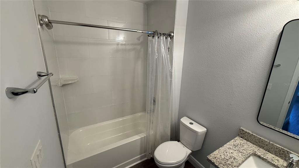 11079 Kimberly Avenue Englewood, FL 34224 - Photo 10 of 14 a bathroom with a toilet and a shower