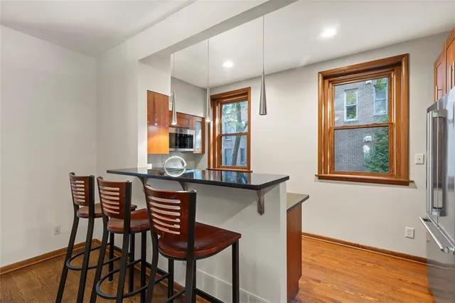 a kitchen with granite countertop stainless steel appliances a refrigerator and a sink