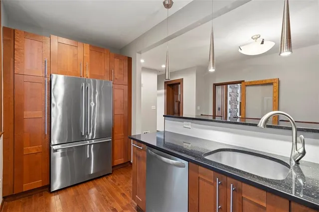 a kitchen with granite countertop a stove and a sink