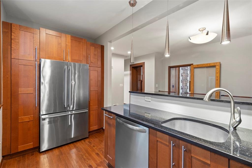 6109 Fifth Avenue, Unit 2 Pittsburgh, PA 15232 - Photo 12 of 31 a kitchen with granite countertop stainless steel appliances a refrigerator and a sink