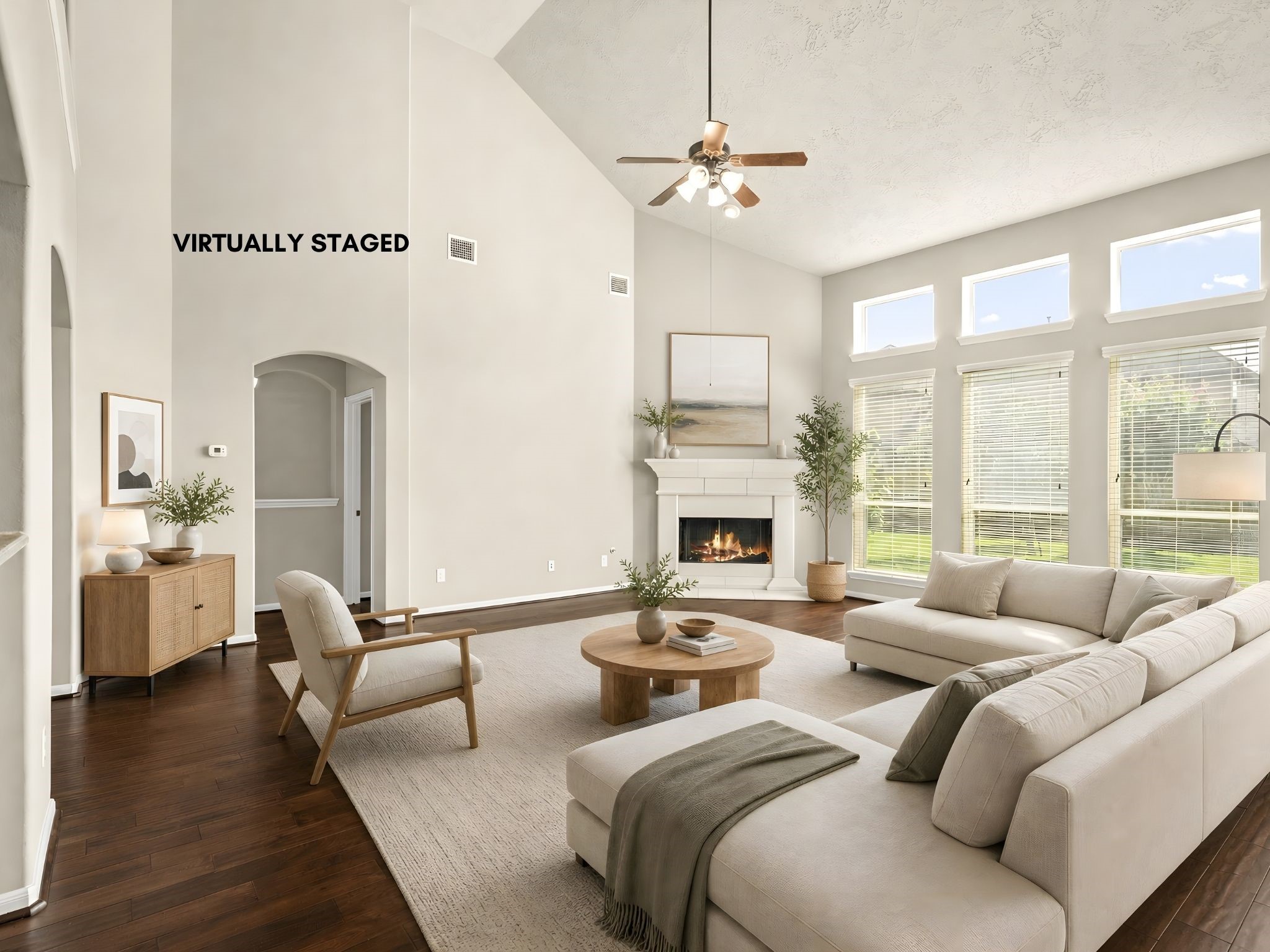 5307 Amber Sky Lane Rosharon, TX 77583 - Photo 12 of 50 Soaring two-story ceilings and a striking gas fireplace anchor this beautifully virtually staged family room, designed to inspire grand-scale gatherings and relaxed evenings alike.