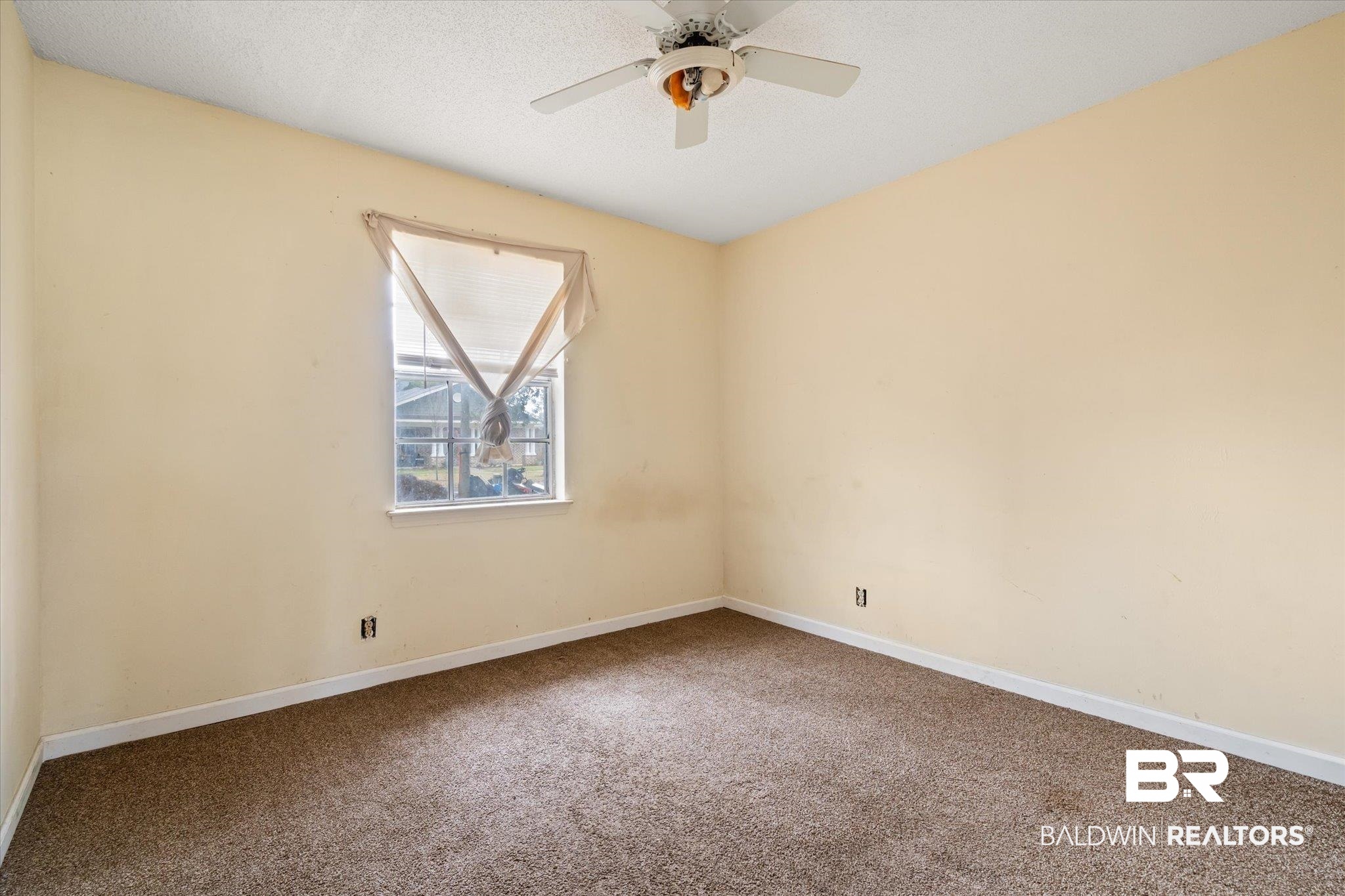 313 West 4th Avenue Foley, AL 36535 - Photo 12 of 20 Empty room with ceiling fan, carpet flooring, and a textured ceiling