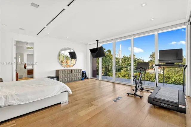 a bedroom with a bed and large flat screen tv