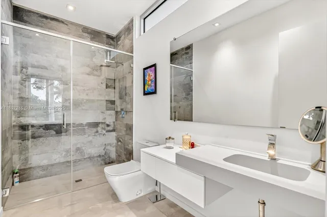 a bathroom with a sink toilet and shower