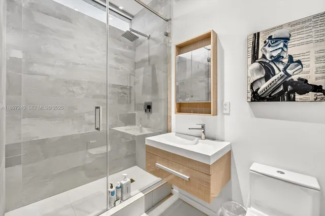 a bathroom with a sink toilet and shower