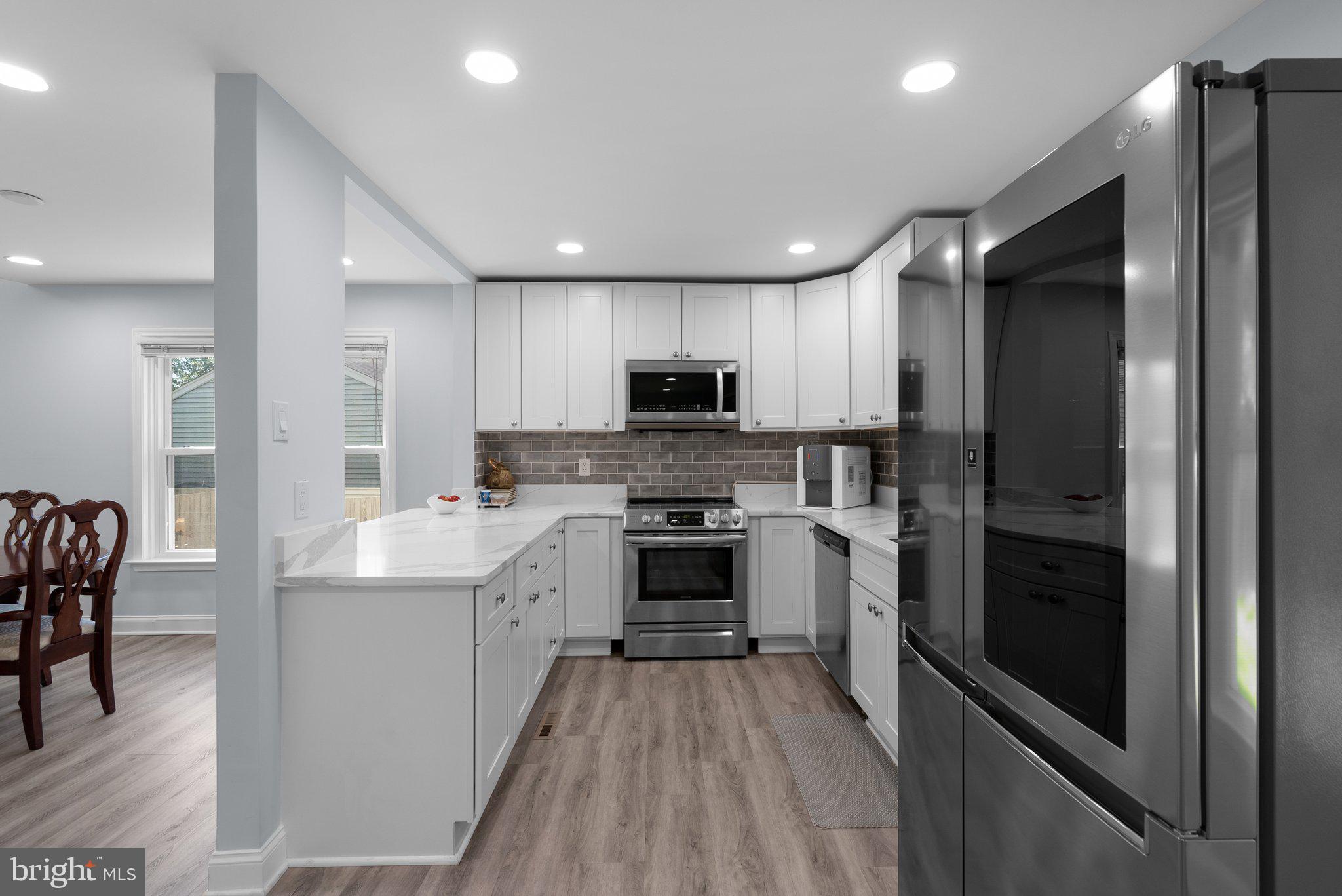 11631 Ranch Lane North Potomac, MD 20878 - Photo 12 of 32 a kitchen with a sink stainless steel appliances and cabinets