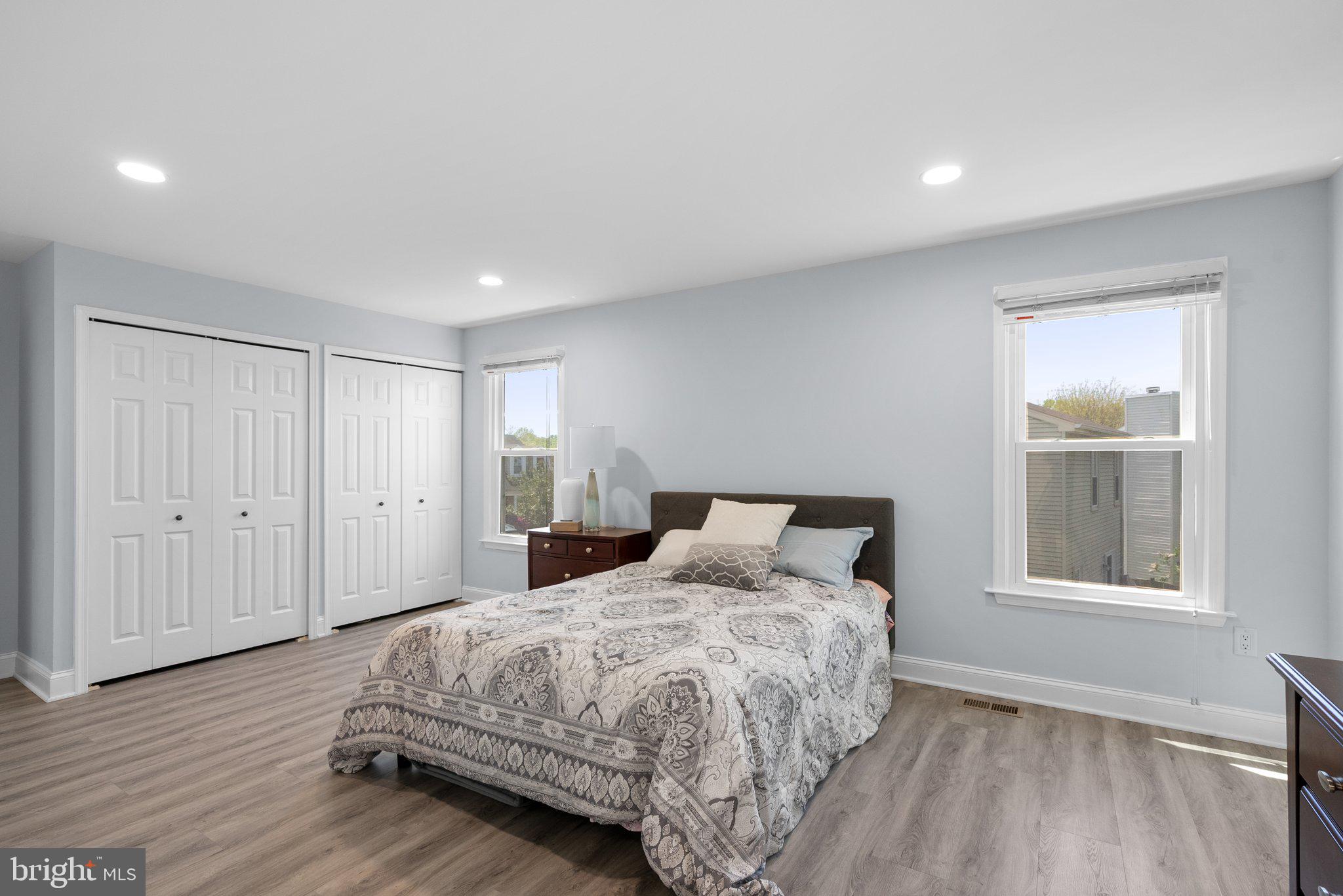11631 Ranch Lane North Potomac, MD 20878 - Photo 20 of 32 a bedroom with a large bed and wooden floor