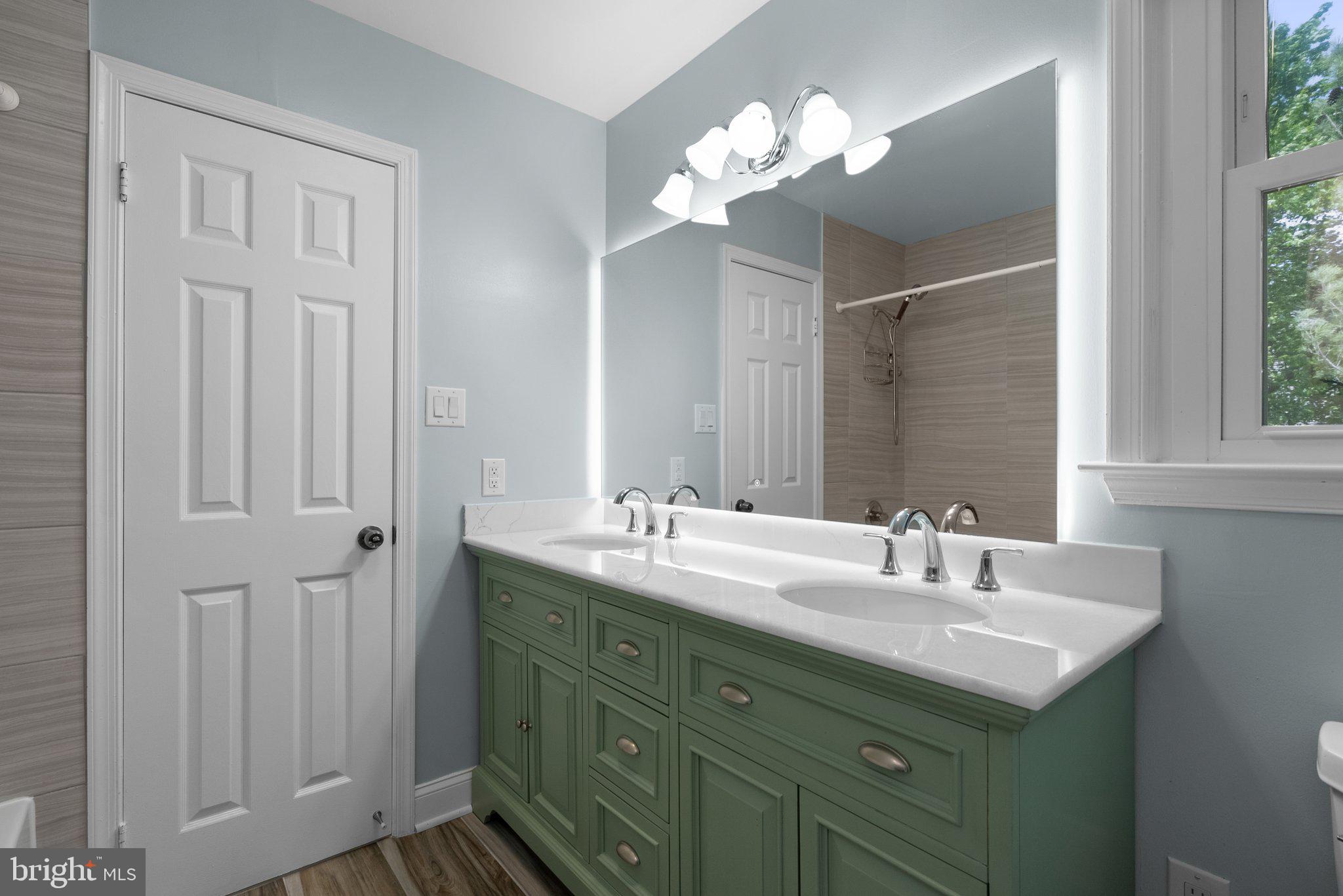 11631 Ranch Lane North Potomac, MD 20878 - Photo 21 of 32 a bathroom with a sink double vanity and a mirror