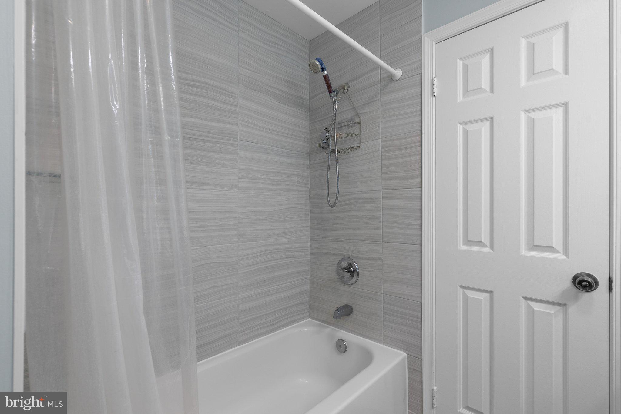 11631 Ranch Lane North Potomac, MD 20878 - Photo 22 of 32 a bathroom with a shower and a tub