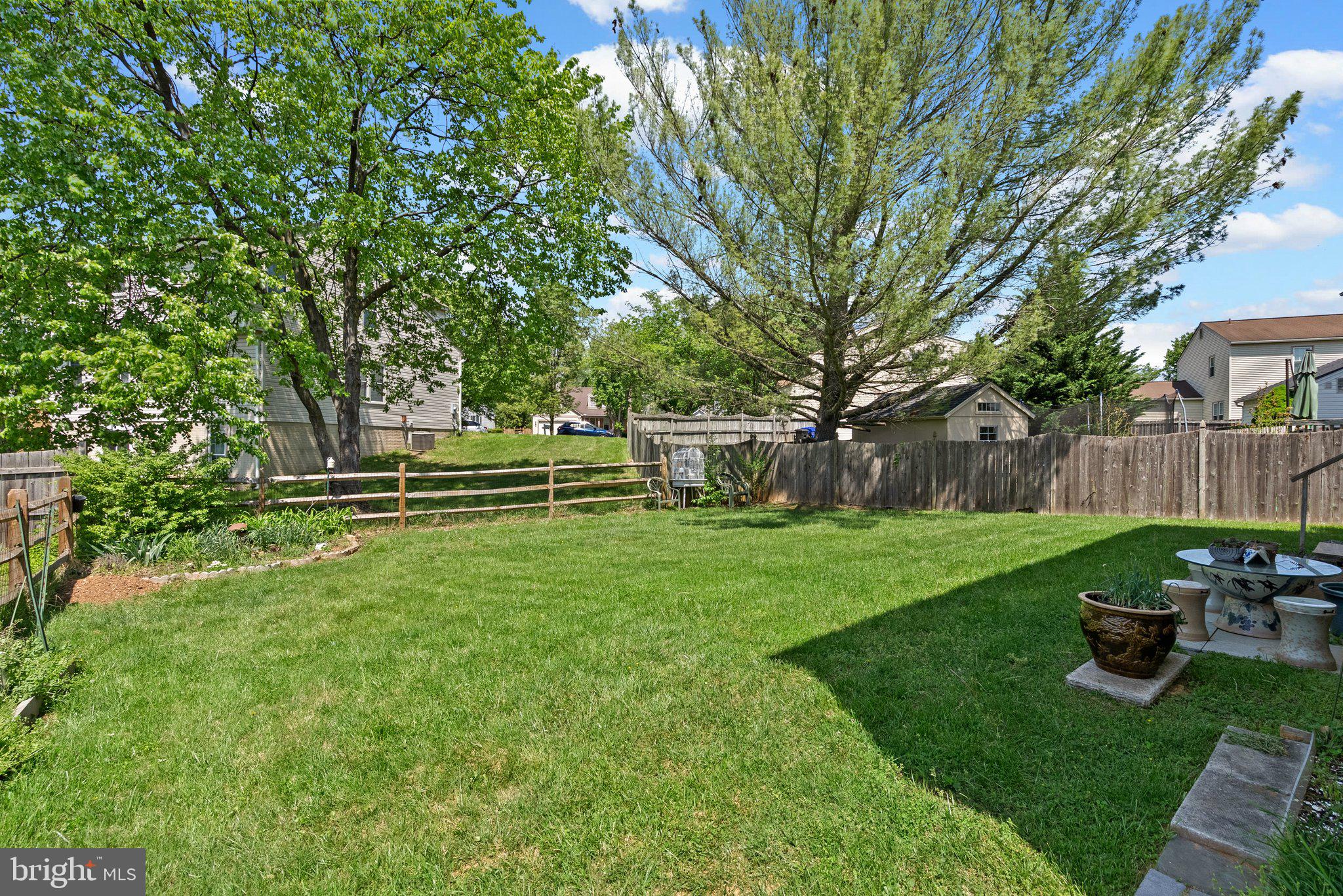 11631 Ranch Lane North Potomac, MD 20878 - Photo 31 of 32 a view of a backyard with table and chairs and wooden fence