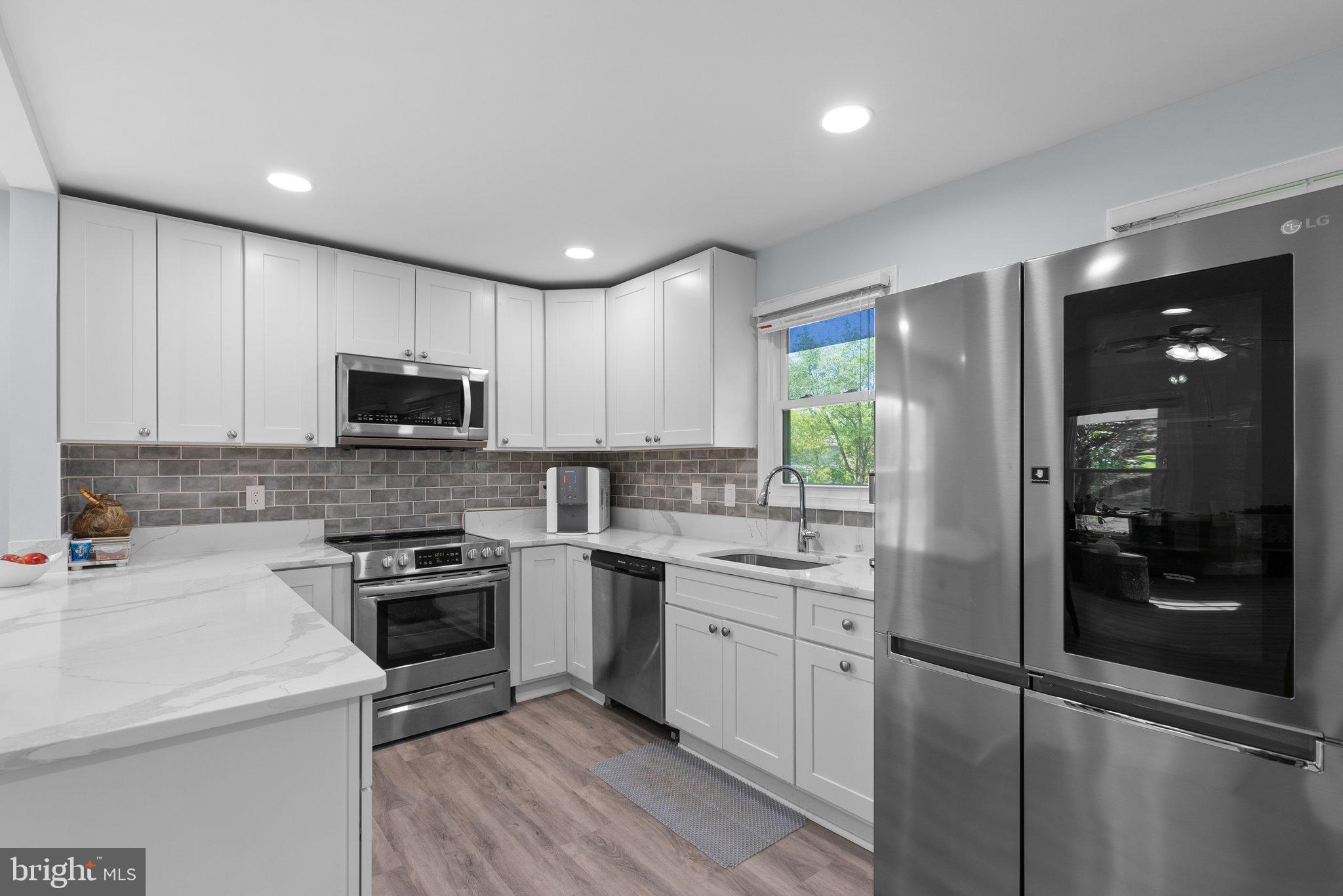 11631 Ranch Lane North Potomac, MD 20878 - Photo 10 of 32 a kitchen with a sink a stove and cabinets