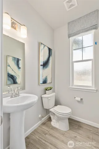 a bathroom with a toilet a sink and a mirror