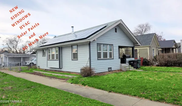 a front view of a house with a yard and porch