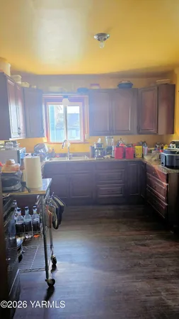 a kitchen with a sink and a stove next to a window