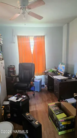 a living room with furniture gym equipment and a window