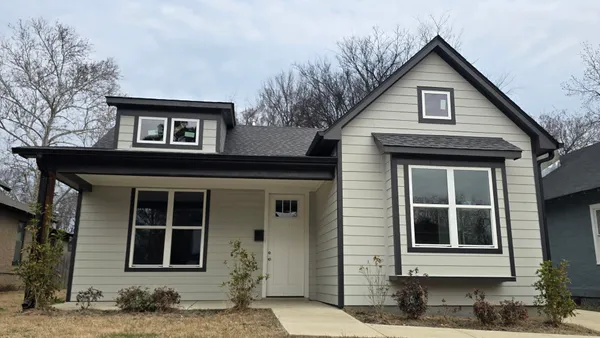 a kitchen with a sink cabinets wooden floor and a window