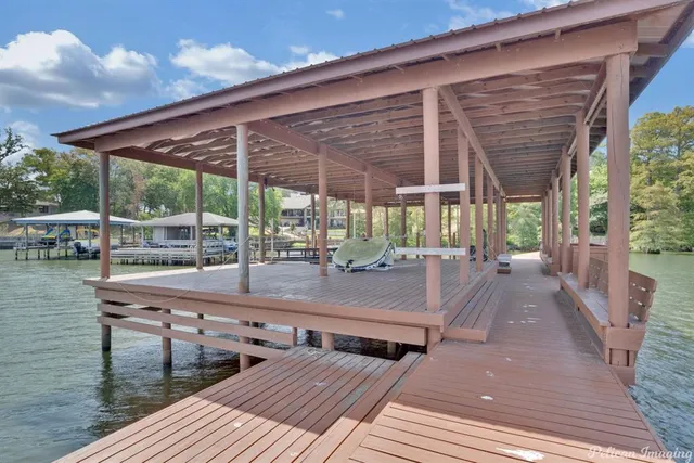 a view of a patio with a table chairs and wooden floor