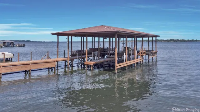 a view of a balcony with wooden floor and potted plants