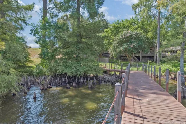 a view of a balcony with wooden floor and lake view