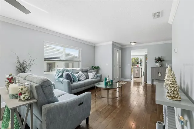 a living room with furniture and wooden floor